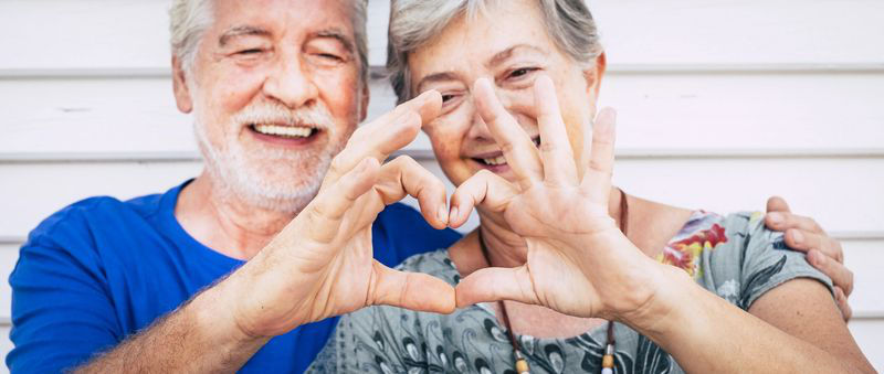 Senior couple making heart with hands